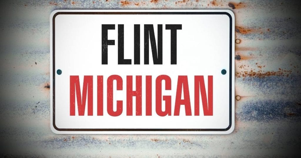 Flint, Michigan road sign representing public health reporting on the Flint water crisis.